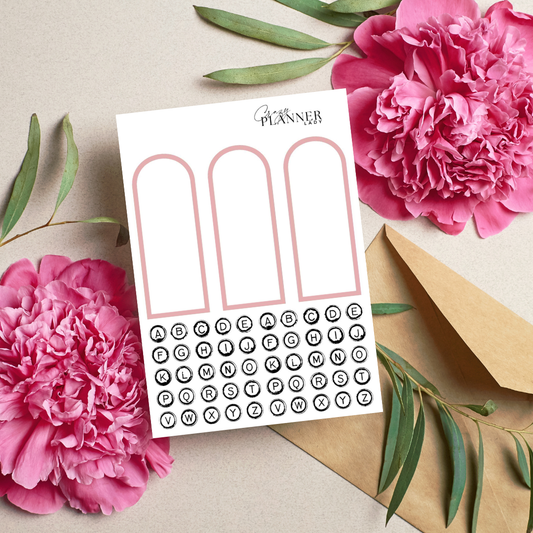 Neutral arch-shaped window sticker cutouts on white sheet